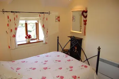 a bedroom with a bed and a window at Tre-Allt Gorgeous Cottage in Dolgellau