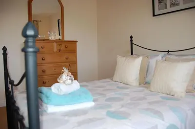 a bed with a dresser and a stuffed animal on it at Ty Pen y Bryn in Dolgellau in Dolgellau