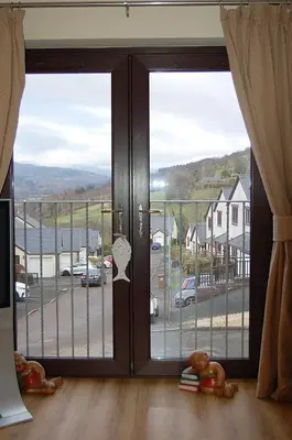an open door with a view of a parking lot at Ty Pen y Bryn in Dolgellau in Dolgellau
