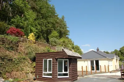 a small cabin in front of a house at Tawel Fryn Bungalow near Dolgellau in Dolgellau
