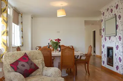 a living room with a couch and a table with chairs at Tawel Fryn Bungalow near Dolgellau in Dolgellau