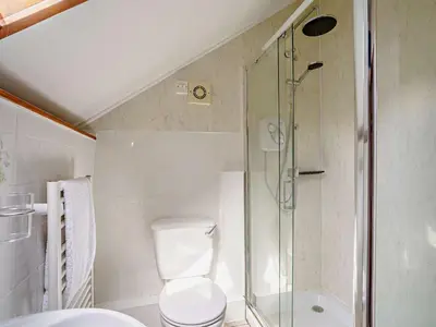 a bathroom with a toilet and a glass shower at 2 Bed in Llanybydder oc-81353 in Llanwenog