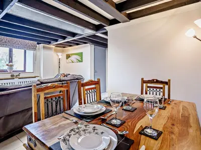 a dining room with a wooden table with wine glasses at 2 Bed in Llanybydder oc-81353 in Llanwenog