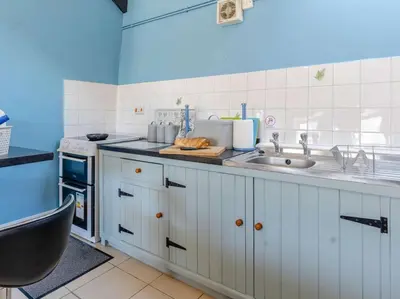 a kitchen with white cabinets and a sink at 1 Bed in Llanybydder oc-81354 in Llanwenog