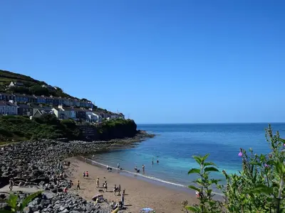 a group of people on a beach near the ocean at 1 Bed in Llanybydder oc-81354 in Llanwenog