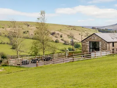 a group of cows in a field next to a barn at 2 Bed in Brecon oc-bn100 in Cray