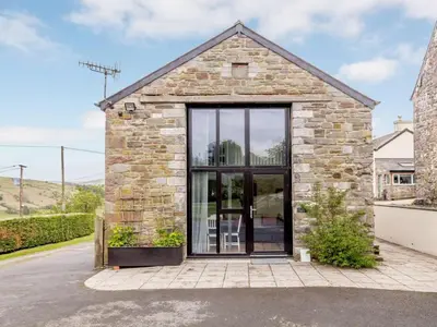 a stone house with a large glass door at 2 Bed in Brecon oc-bn100 in Cray