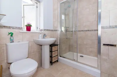 a bathroom with a toilet sink and a shower at Elegant Ludlow Haven: 4Bed Ultimate Tranquility in Ludlow