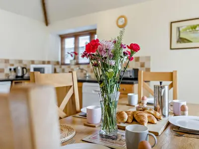 a table with a vase of flowers and croissants on it at 2 Bed in Shrewsbury oc-47795 in Ryton