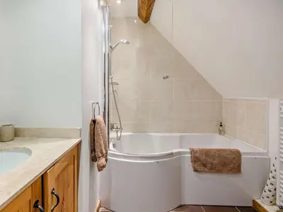 a white bathroom with a tub and a sink at 2 Bed in Shrewsbury oc-47795 in Ryton