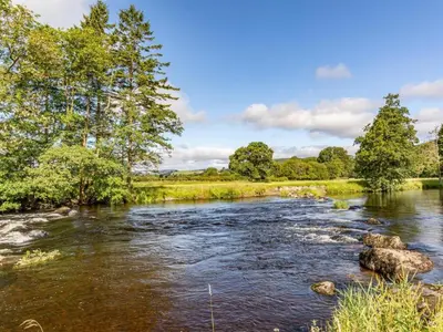 a river with trees on the side of it at 4 Bed in Bala oc-75288 in Llandderfel