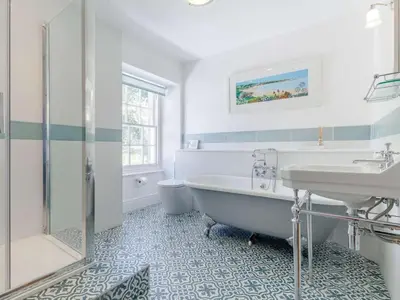 a white bathroom with a tub and a sink at 3 Bed in Brecon oc-bn331 in Cathedine