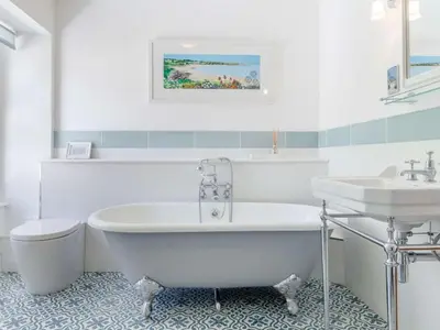 a white bathroom with a tub and a sink at 3 Bed in Brecon oc-bn331 in Cathedine