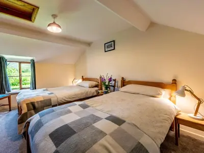 a bedroom with two beds and a window at 4 Bed in Hereford oc-86497 in Llanveynoe