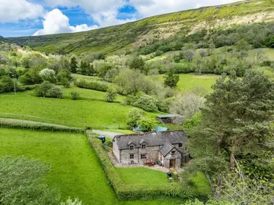 an aerial view of a house in a field at 4 Bed in Hereford oc-86497 in Llanveynoe