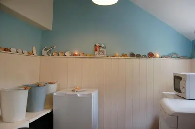 a bathroom with two toilets and a shelf with dishes at Cadair View Family Holiday Home in Tywyn