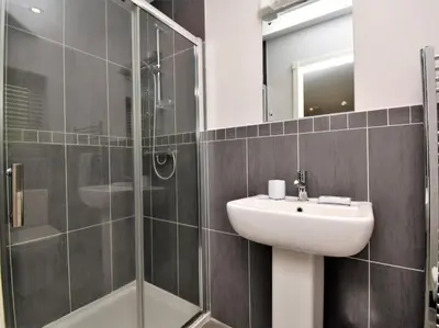 a bathroom with a sink and a glass shower at 4 Bed in Oswestry oc-74110 in Kinnerley