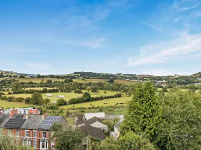 an aerial view of a village with houses and a field at 2 Bed in Corwen oc-77351 in Corwen