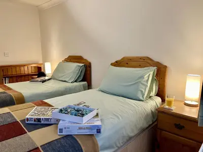 a hotel room with two beds with boxes on them at Caer Dderwen Oak Field family home in Dolgellau in Dolgellau