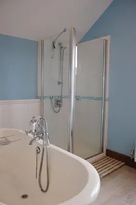 a bath tub in a bathroom with a shower at Idris View Family Holiday Home in Tywyn