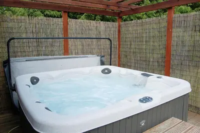 a large bath tub sitting on a patio at Glan yr Afon in Dolgellau in Dolgellau