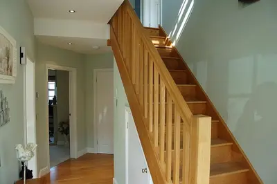 a wooden staircase in a home with a hallway at Glan yr Afon in Dolgellau in Dolgellau