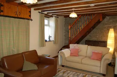 a living room with a couch and a chair at Glyn Saron near Tywyn in Bryn-crug