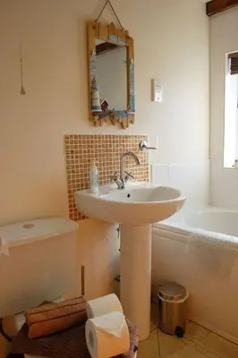 a bathroom with a sink and a bath tub at Glyn Saron near Tywyn in Bryn-crug