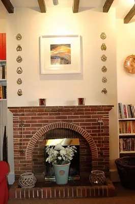a living room with a brick fireplace at Minafon near Barmouth in Llanaber