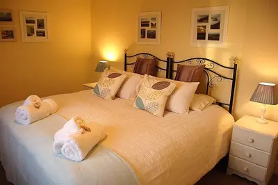 a bedroom with a bed with towels on it at Minafon near Barmouth in Llanaber