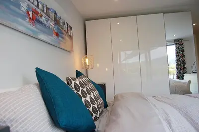 a bedroom with a bed with blue and white pillows at Paradwys in Dolgellau in Dolgellau