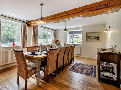 a dining room with a long table and chairs at 6 Bed in Brecon oc-bn171 in Llanspyddid