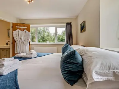 a bedroom with two beds and a window at 6 Bed in Brecon oc-bn171 in Llanspyddid