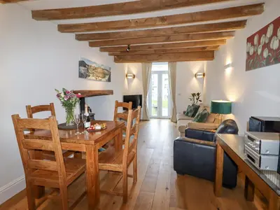 a living room with a table and a couch at No 9 On The Riverbank in Llangollen