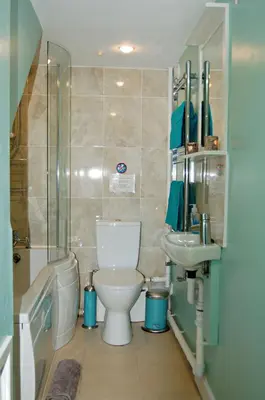 a bathroom with a toilet and a sink and a shower at Sand Dune Apartment in Barmouth in Barmouth