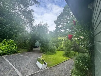a backyard with a garden with plants and trees at 1 Bed in Llanidloes oc-56492 in Van