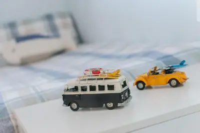 two toy cars with surfboards on top at Sound of the Sea, beach front Bungalow with hot tub, in Tywyn in Tywyn