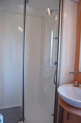 a bathroom with a shower and a sink at Caravan 251 Bryn Y Mor Beach Side Park in Tywyn