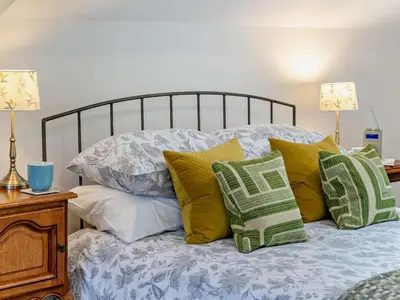 a bed with green and white pillows on it at 1 Bed in Brecon oc-bn157 in Llangorse