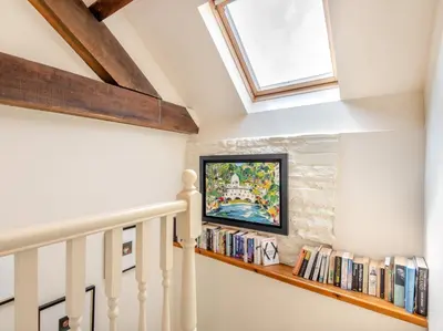 a staircase with a book shelf filled with books at 1 Bed in Clyro BN290 in Clyro