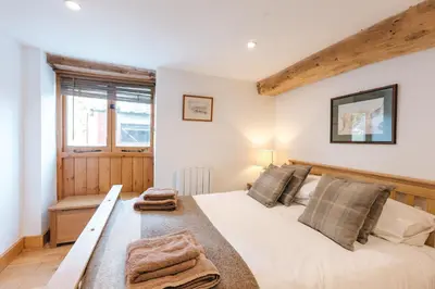 a bedroom with a large bed with towels on it at ryton grange hay barn sleeps 6 in Shrewsbury