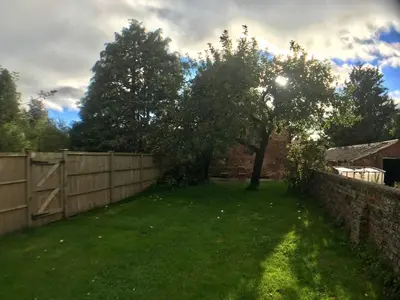 a yard with a fence and a tree at ryton grange hay barn sleeps 6 in Shrewsbury