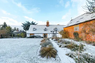 a house with snow on the ground in front of it at ryton grange hay barn sleeps 6 in Shrewsbury