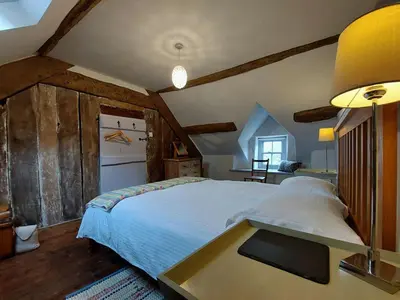 a bedroom with a bed and a table in it at CaeEinion Cottage a Georgeous Rural Retreat Nr Dolgellau in Dolgellau
