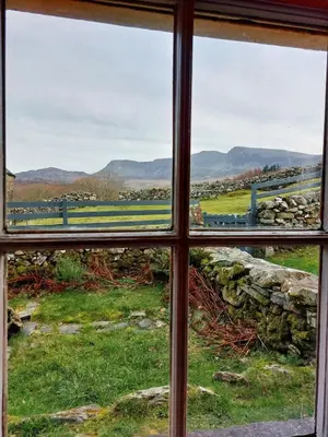 a window with a view of a field seen through it at CaeEinion Cottage a Georgeous Rural Retreat Nr Dolgellau in Dolgellau