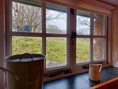 a window in a kitchen looking out at a field at CaeEinion Cottage a Georgeous Rural Retreat Nr Dolgellau in Dolgellau