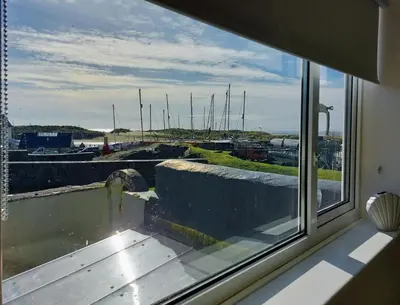 a window in a room with a view of a harbor at Craig View Fishermans Cottage nr Harbour and Beach in Barmouth