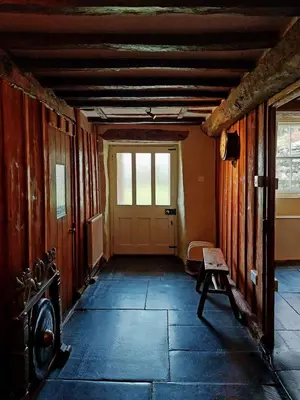 an empty room with a door and a bench at Gallestra a Rustic, Rural Retreat Farm House Nr Dolgellau Snowdonia in Dolgellau