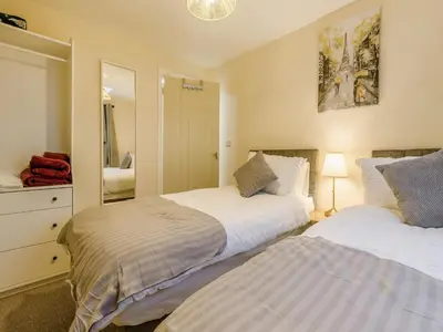 a bedroom with two beds and a mirror at Brewers Cottage-Uk45454 in Montgomery