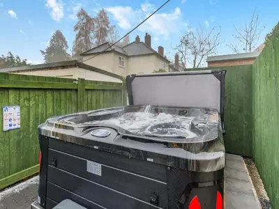 a barbecue grill sitting on the side of a fence at Brewers Cottage-Uk45454 in Montgomery